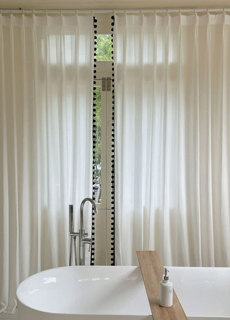 a white bath tub sitting next to a window