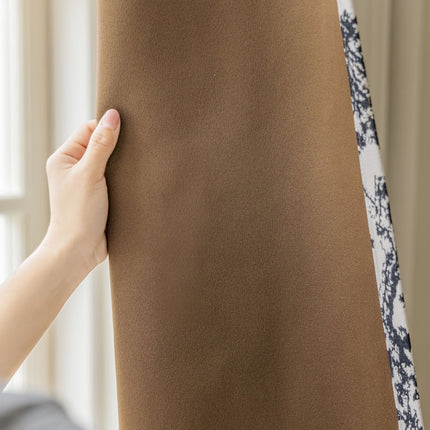 a person is holding up a brown sheet