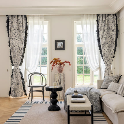 a living room filled with furniture and a large window