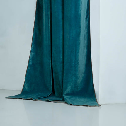 a green curtain with a white wall in the background