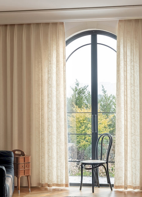 a living room with a black couch and a chair