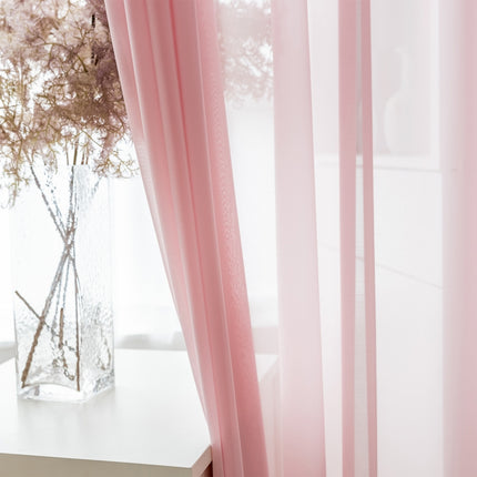a vase of flowers sitting on a table next to a window