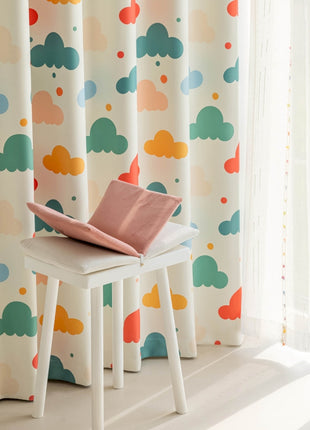 a small white table with a pink pillow on top of it