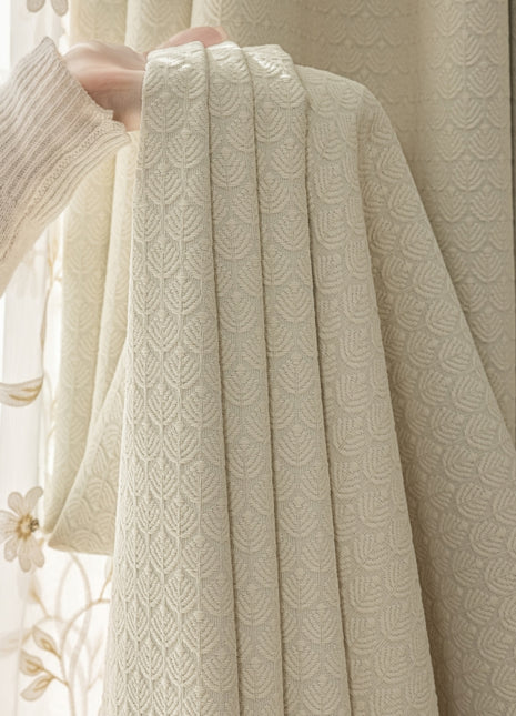 a person holding a curtain in front of a window