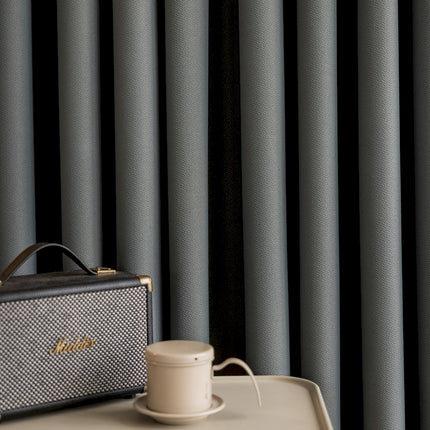 a suitcase sitting on top of a table next to a cup of coffee