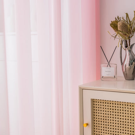 a vase of flowers on a dresser next to a window