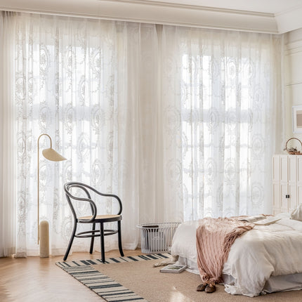 a bedroom with a bed, a chair and a window