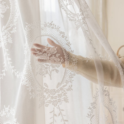 a woman's hand is seen through a sheer curtain