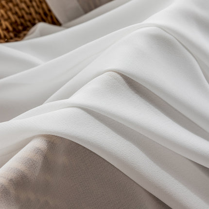 a close up of a bed with white sheets