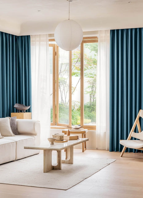 a living room filled with furniture and a large window