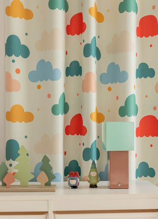 a teddy bear sitting on a dresser next to a window