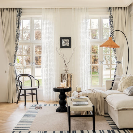 a living room filled with furniture and a large window