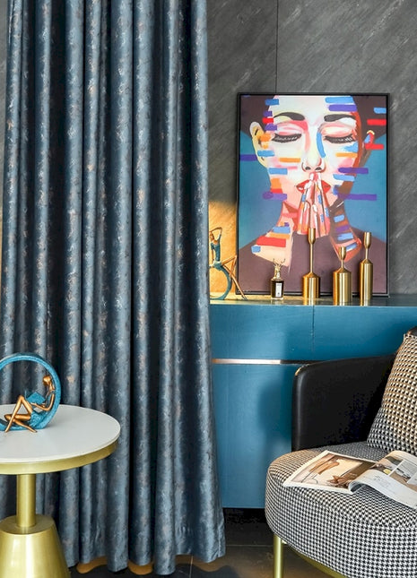 a living room with a chair and a painting on the wall